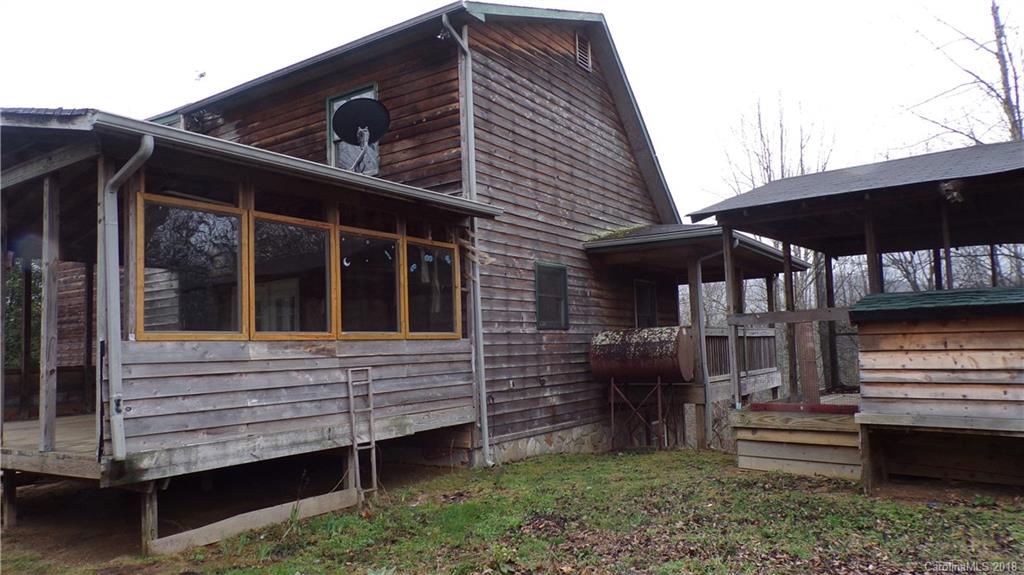 185 Mountain Mission Road Clyde, NC 28721 - Photo 2 of 23 a view of a house with a window and wooden fence