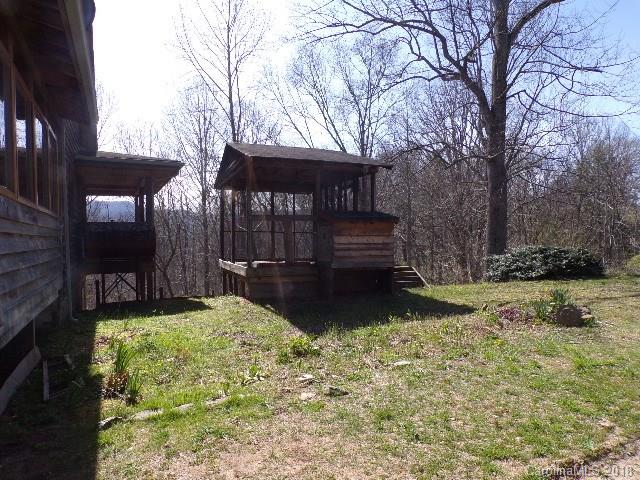 185 Mountain Mission Road Clyde, NC 28721 - Photo 16 of 23 a view of a backyard with large trees