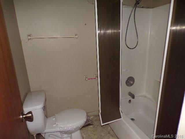 185 Mountain Mission Road Clyde, NC 28721 - Photo 20 of 23 a white toilet sitting next to a bath tub