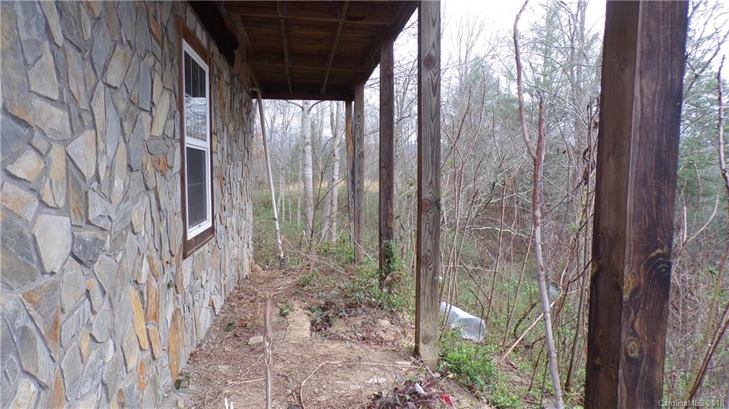 185 Mountain Mission Road Clyde, NC 28721 - Photo 3 of 23 a backyard of a house with lots of green space