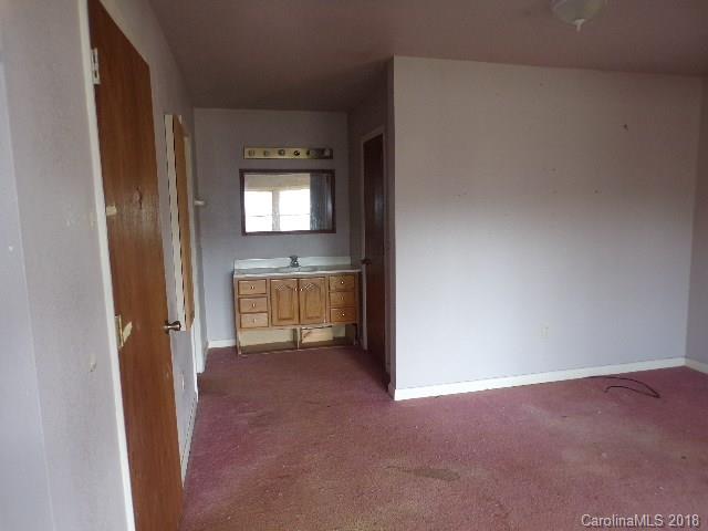 185 Mountain Mission Road Clyde, NC 28721 - Photo 21 of 23 a view of a hallway to an empty room with a kitchen