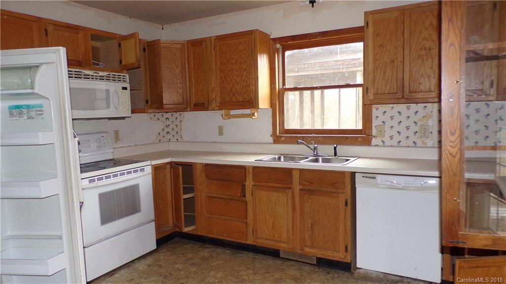 185 Mountain Mission Road Clyde, NC 28721 - Photo 6 of 23 a kitchen with stainless steel appliances granite countertop a sink stove and cabinets