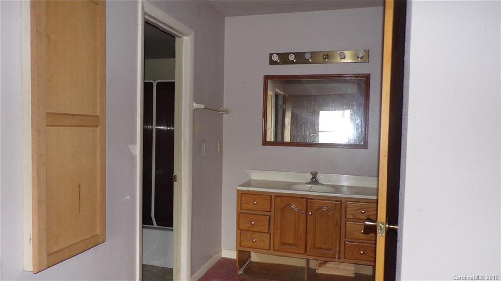 185 Mountain Mission Road Clyde, NC 28721 - Photo 9 of 23 a view of front door with a sink and mirror