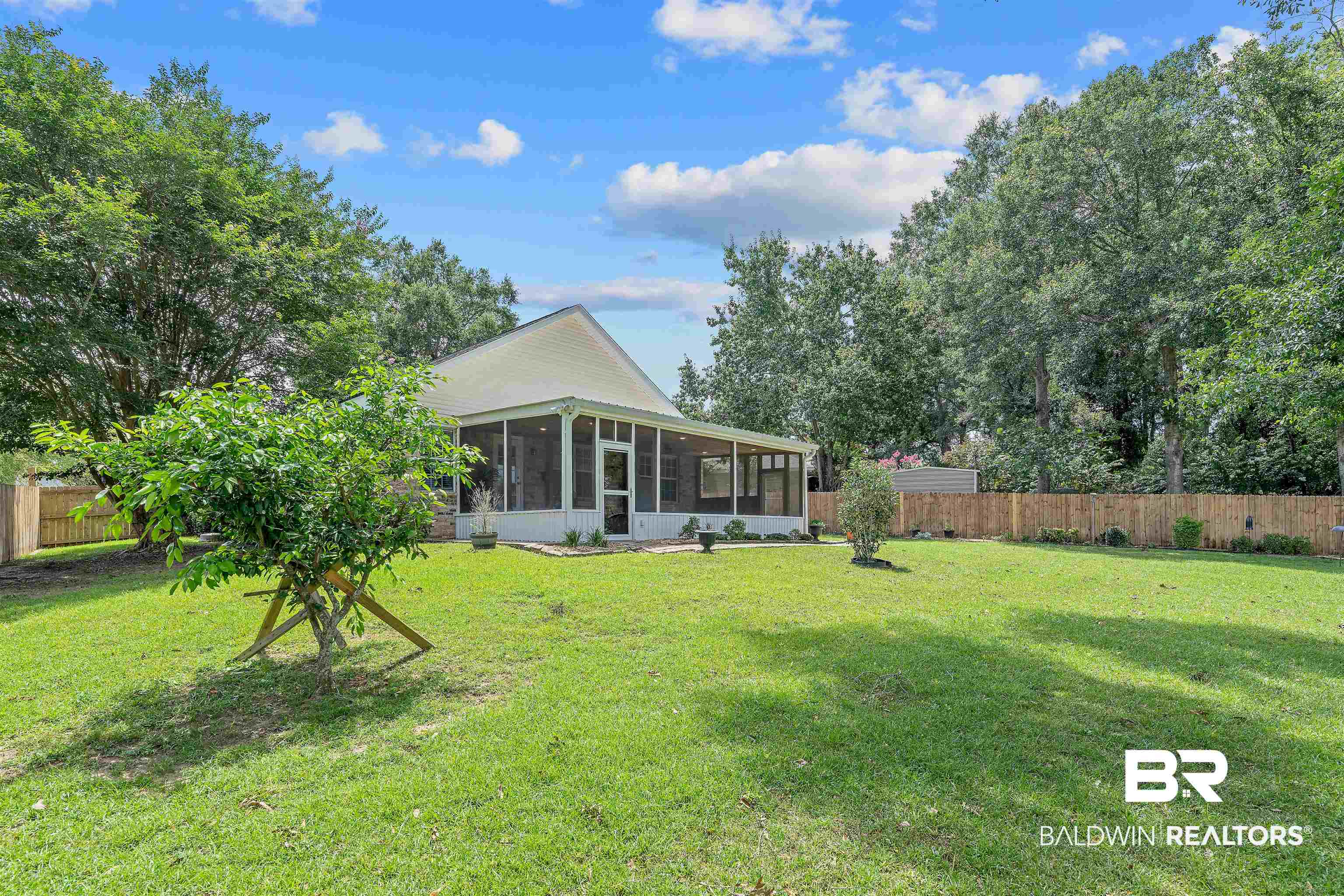 11097 Pontchartrain Loop Daphne, AL 36526 - Photo 6 of 28 Rear view of property featuring a sunroom and a fenced backyard