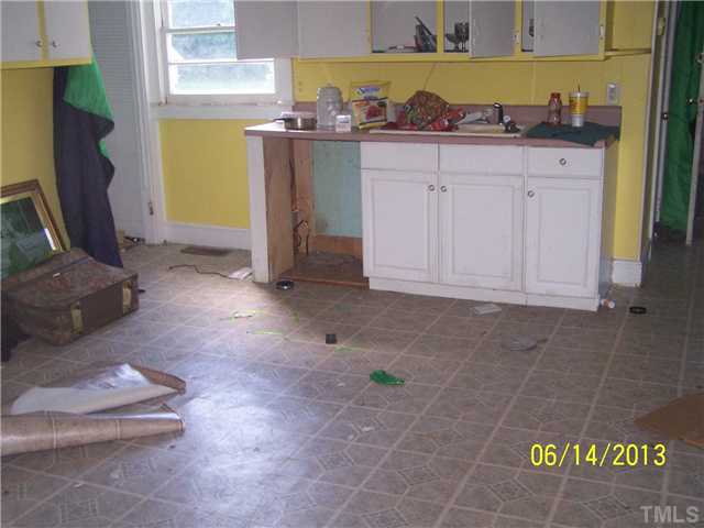 6711 Oxford Road Timberlake, NC 27583 - Photo 3 of 5 a dining room with granite countertop furniture and a fireplace