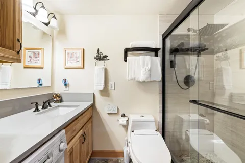 a bathroom with a toilet and a shower