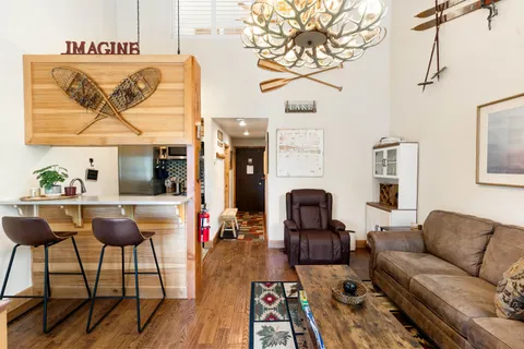 a dining room with furniture and wooden floor