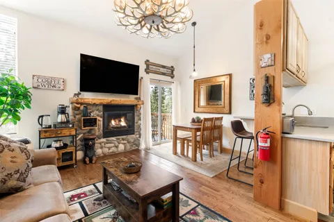 a living room with furniture fireplace and flat screen tv