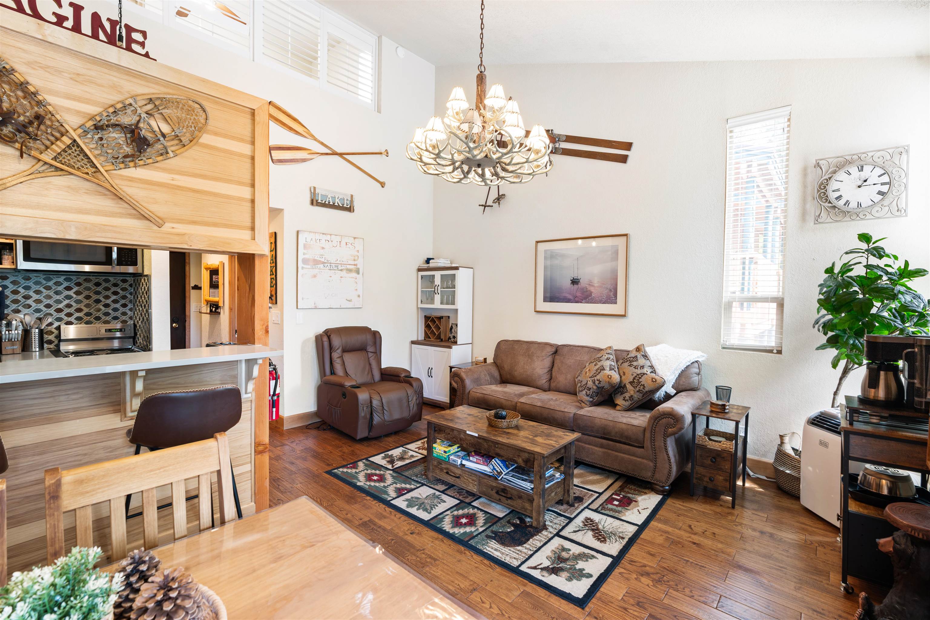 1300 Regency Way, Unit 37 Tahoe Vista, CA 96148 - Photo 3 of 27 a living room with furniture a chandelier and a fireplace
