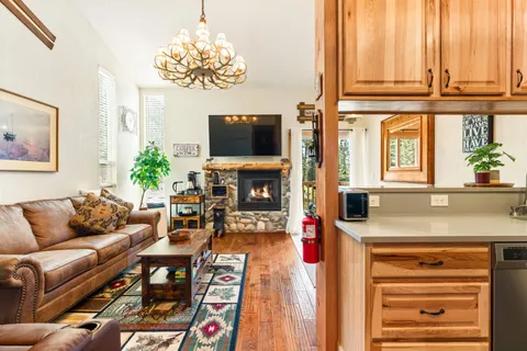 a living room with fireplace furniture and a flat screen tv