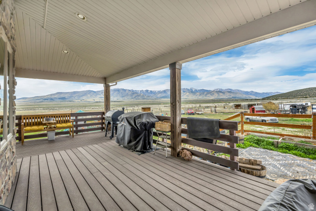 3054 West Ridgeline Road Stockton, UT 84071 - Photo 7 of 88 Wooden terrace featuring a grill, a view of countryside, and a mountain view