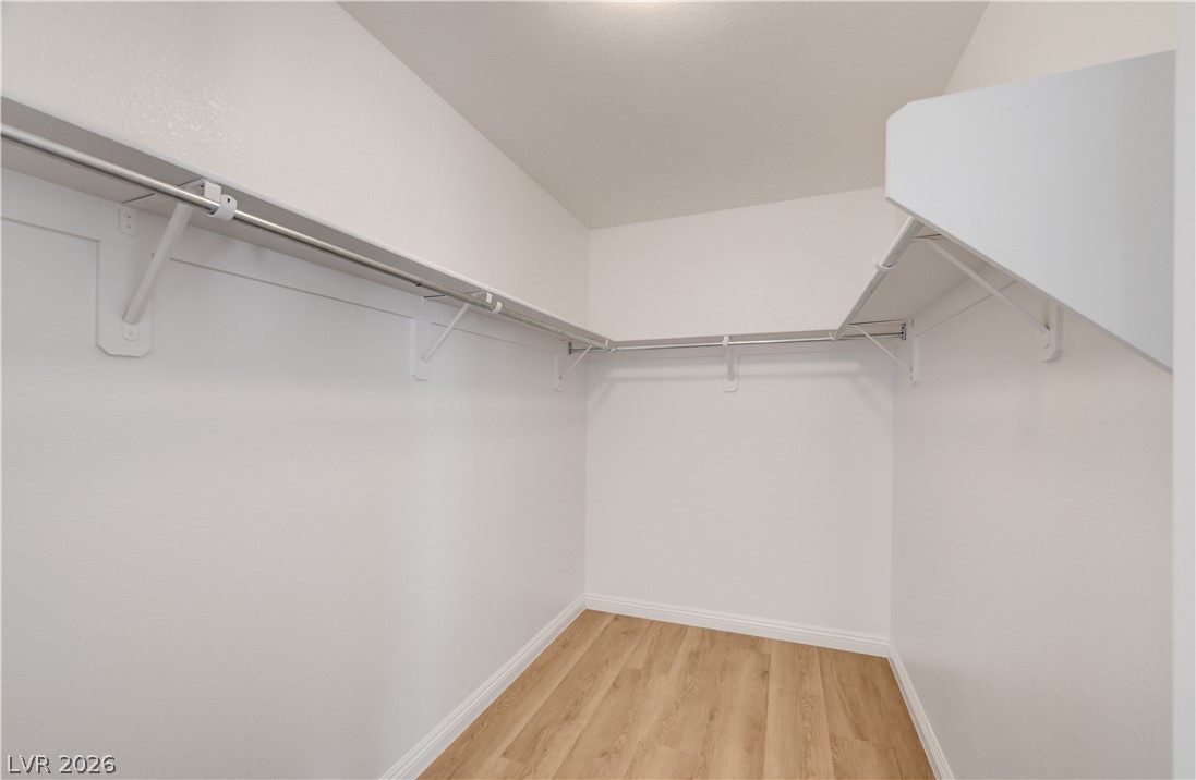 8918 Houston Ridge Avenue Las Vegas, NV 89178 - Photo 21 of 35 Ample shelving and hanging space defines this well-organized walk-in closet.