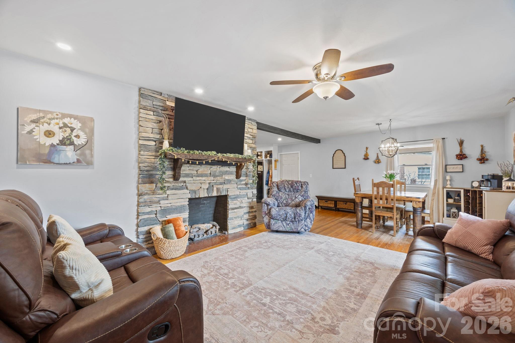 275 Tanner Street Rutherfordton, NC 28139 - Photo 17 of 44 a living room with furniture a fireplace and a flat screen tv