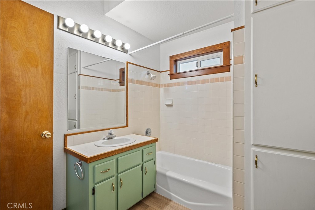 529 South Shasta Street Willows, CA 95988 - Photo 22 of 29 a bathroom with a sink mirror and a bathtub