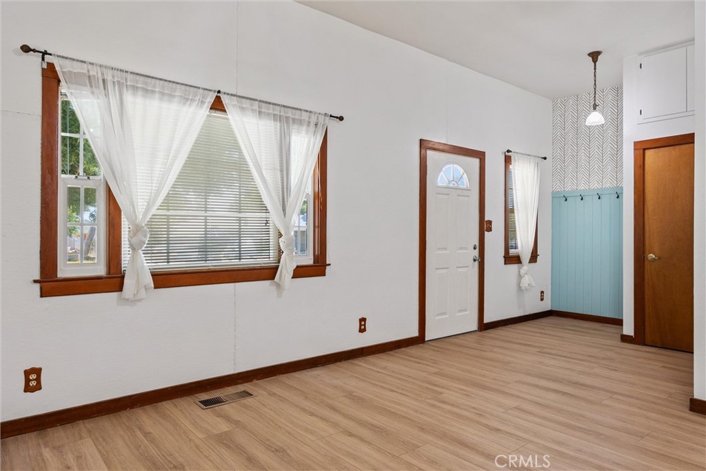 529 South Shasta Street Willows, CA 95988 - Photo 5 of 29 a view of an empty room with wooden floor and a window