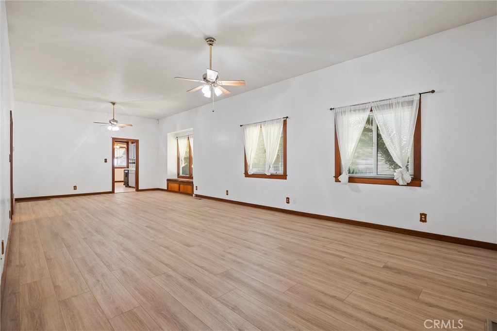 529 South Shasta Street Willows, CA 95988 - Photo 6 of 29 an empty room with wooden floor chandelier and glass door