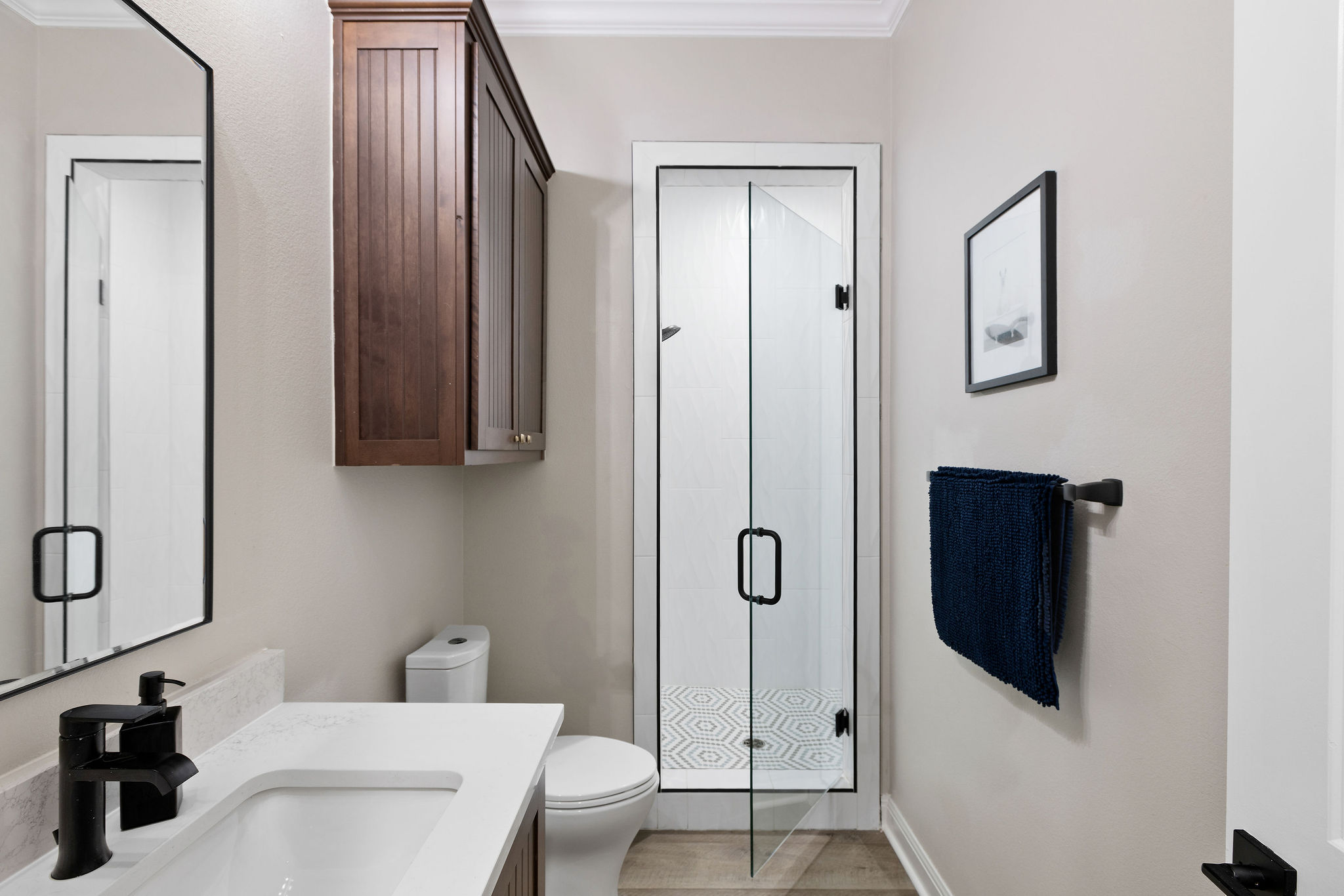 279 Rugged Earth Drive Austin, TX 78737 - Photo 26 of 39 A well-appointed bathroom features a modern glass shower and stylish vanity with sleek fixtures.