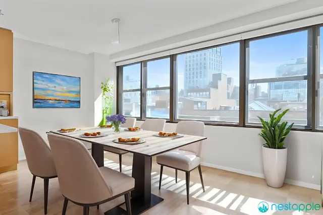 a view of a dining room with furniture window and wooden floor