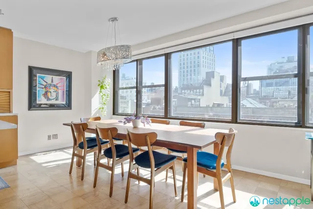 a view of a dining room with furniture large windows and wooden floor