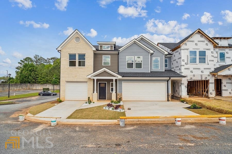 4011 Redan Road, Unit 1 Stone Mountain, GA 30083 - Photo 1 of 1 a front view of a house with a yard