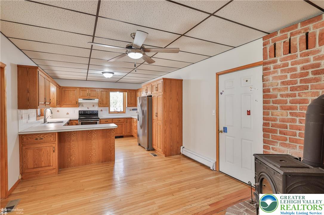 9160 Furnace Road Slatington, PA 18080 - Photo 29 of 52 a large kitchen with stainless steel appliances granite countertop a large stove a sink dishwasher and a refrigerator with wooden floor
