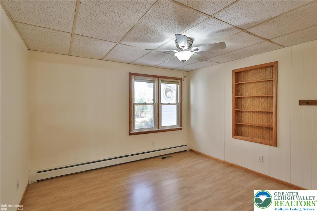 9160 Furnace Road Slatington, PA 18080 - Photo 40 of 52 an empty room with wooden floor chandelier fan and windows