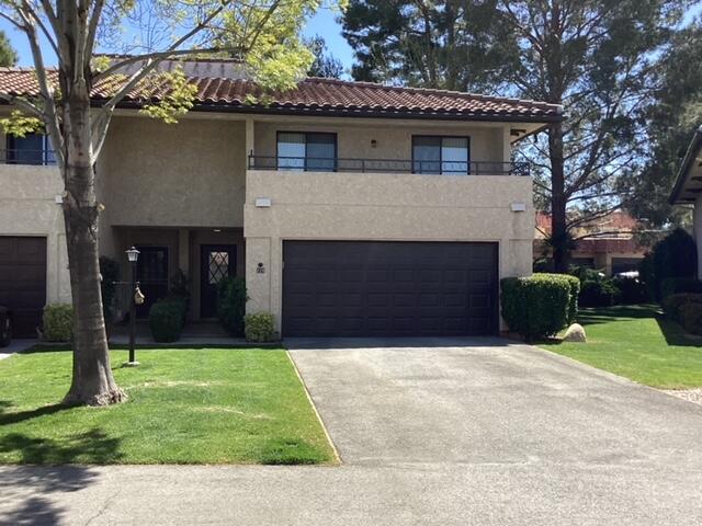 228 Eagle Lane Palmdale, CA 93551 - Photo 1 of 17 a front view of a house with a yard and garage