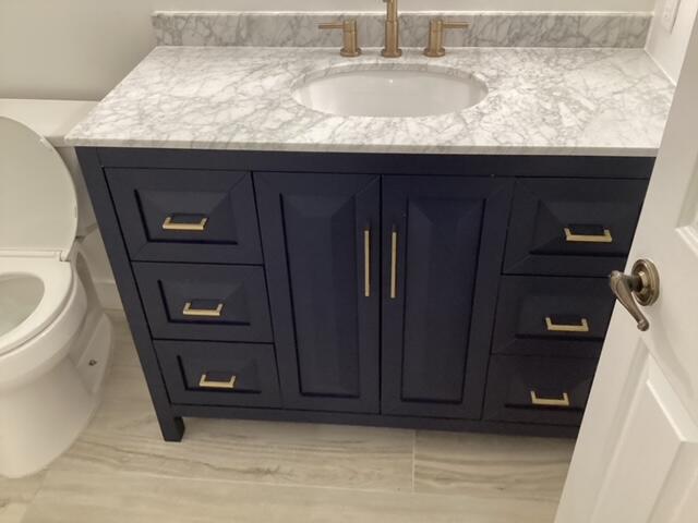 228 Eagle Lane Palmdale, CA 93551 - Photo 11 of 17 a bathroom with a granite countertop sink and a toilet