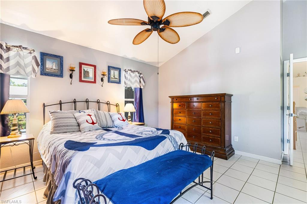 8241 Albatross Road Fort Myers, FL 33967 - Photo 18 of 48 a bedroom with a bed and dresser