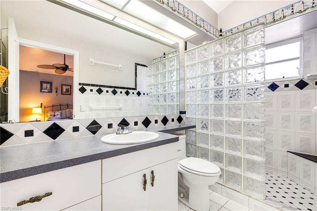 8241 Albatross Road Fort Myers, FL 33967 - Photo 19 of 48 a bathroom with a sink a toilet and shower