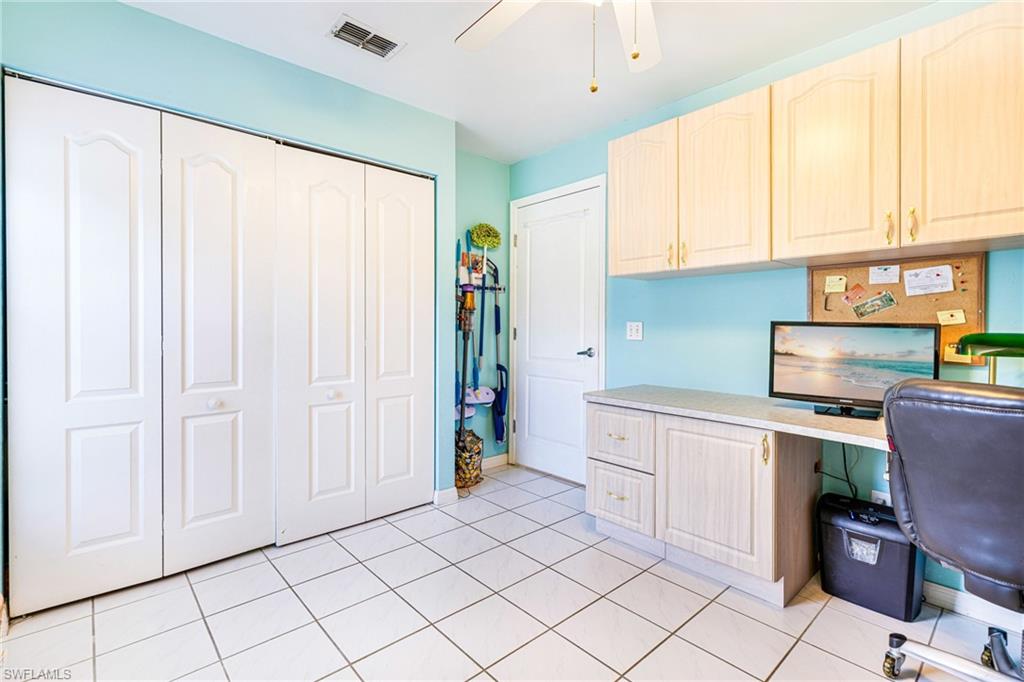 8241 Albatross Road Fort Myers, FL 33967 - Photo 26 of 48 a kitchen with white cabinets a sink and a window