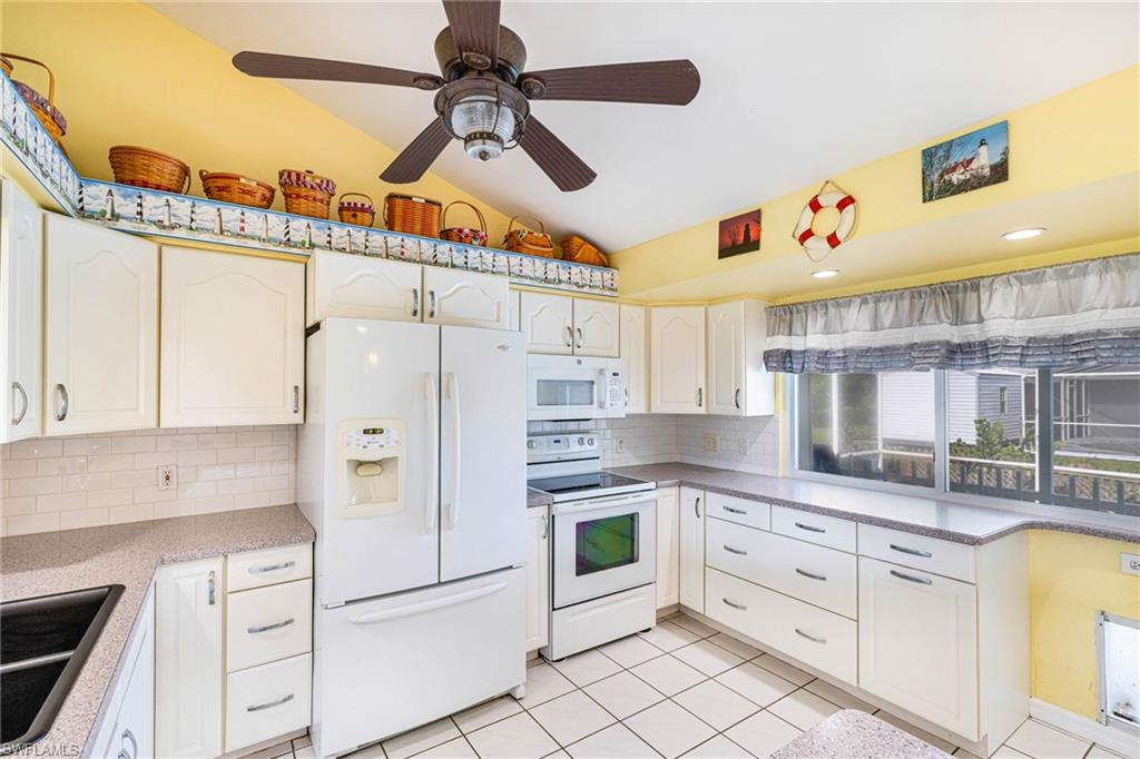 8241 Albatross Road Fort Myers, FL 33967 - Photo 6 of 48 a kitchen with cabinets stainless steel appliances and a window