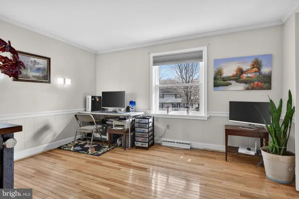 a view of a workspace with furniture window and wooden floor