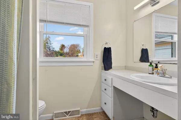 a bathroom with a sink a vanity and a mirror