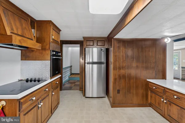 a kitchen with granite countertop a refrigerator and a sink