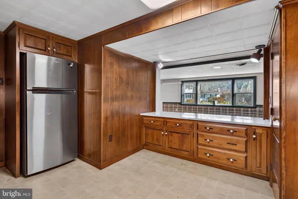 a room with a refrigerator and a sink