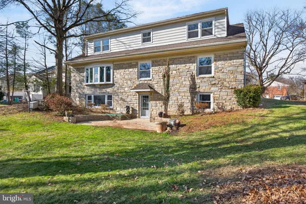 a view of a house with backyard porch and sitting area