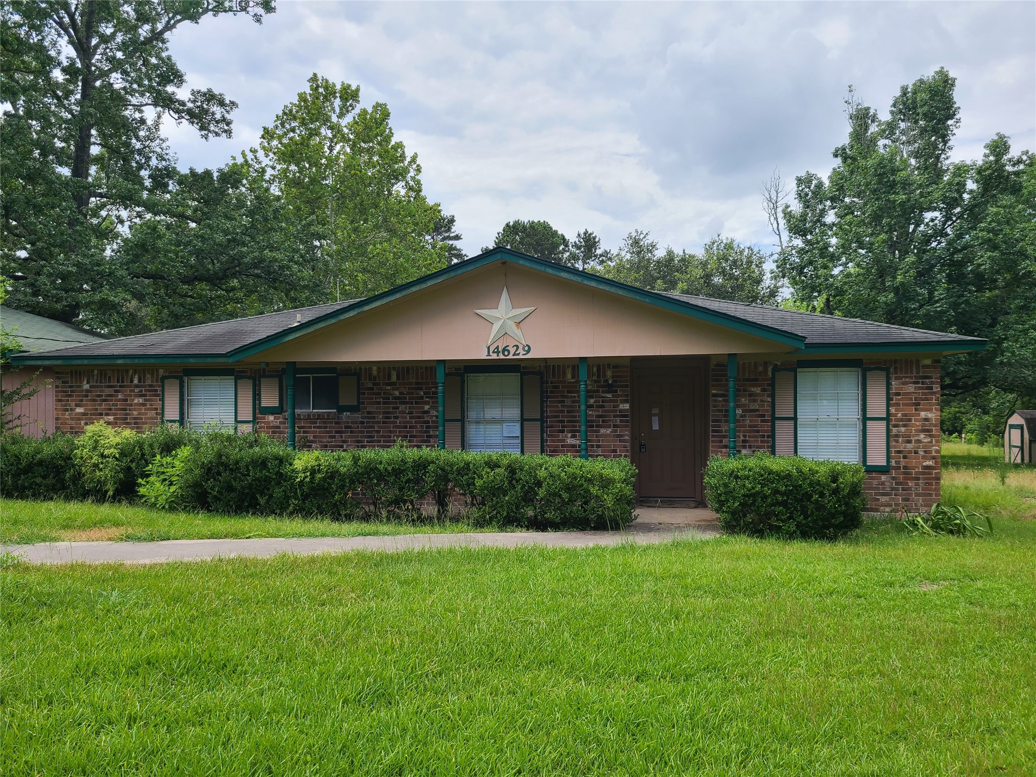 14629 McGregor Road Conroe, TX 77302 - Photo 1 of 11 a front view of a house with a yard