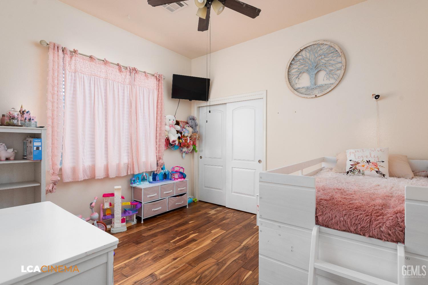 Undisclosed Address Shafter, CA 93263 - Photo 13 of 25 a bedroom with a bed and a chandelier