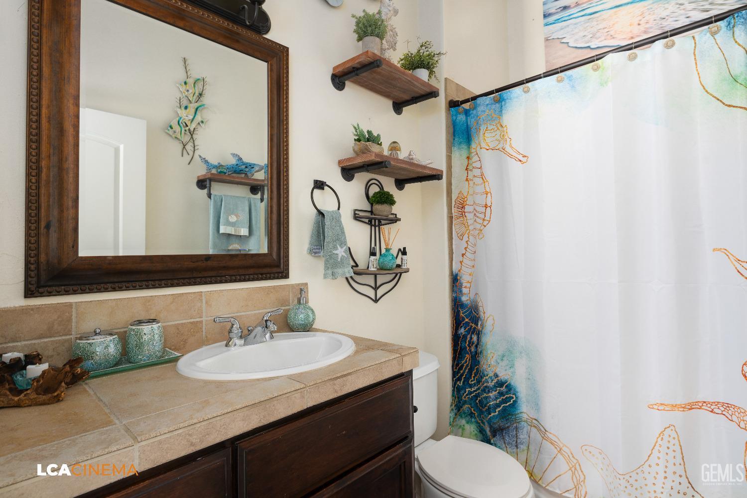 Undisclosed Address Shafter, CA 93263 - Photo 14 of 25 a bathroom with a granite countertop sink a toilet and a mirror