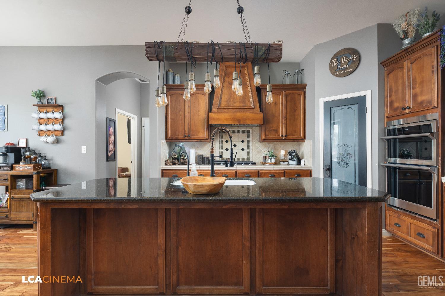 Undisclosed Address Shafter, CA 93263 - Photo 7 of 25 a kitchen with a refrigerator and a sink