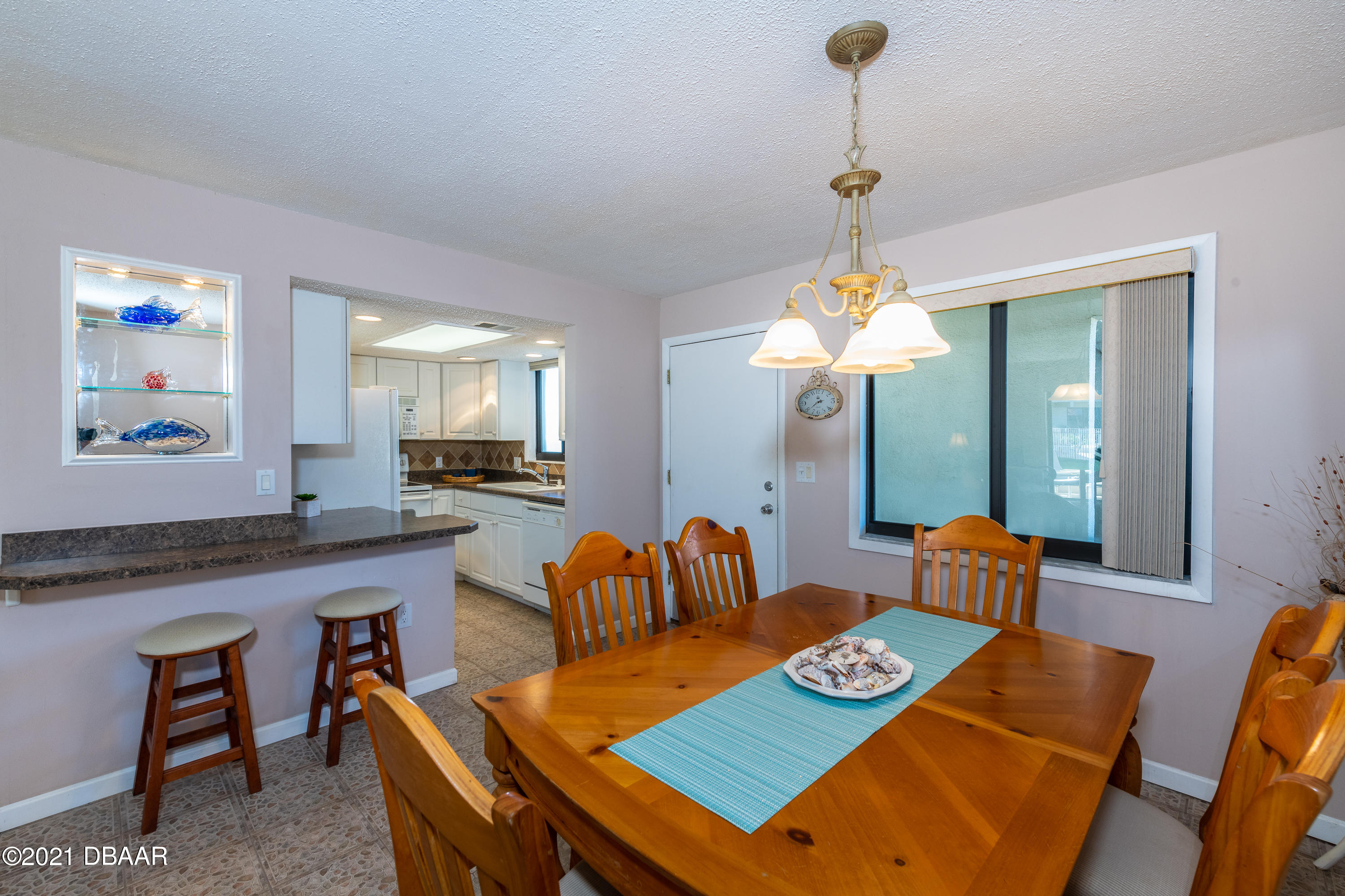 935 Ocean Shore Boulevard, Unit 110 Ormond Beach, FL 32176 - Photo 13 of 21 a living room with furniture and a chandelier