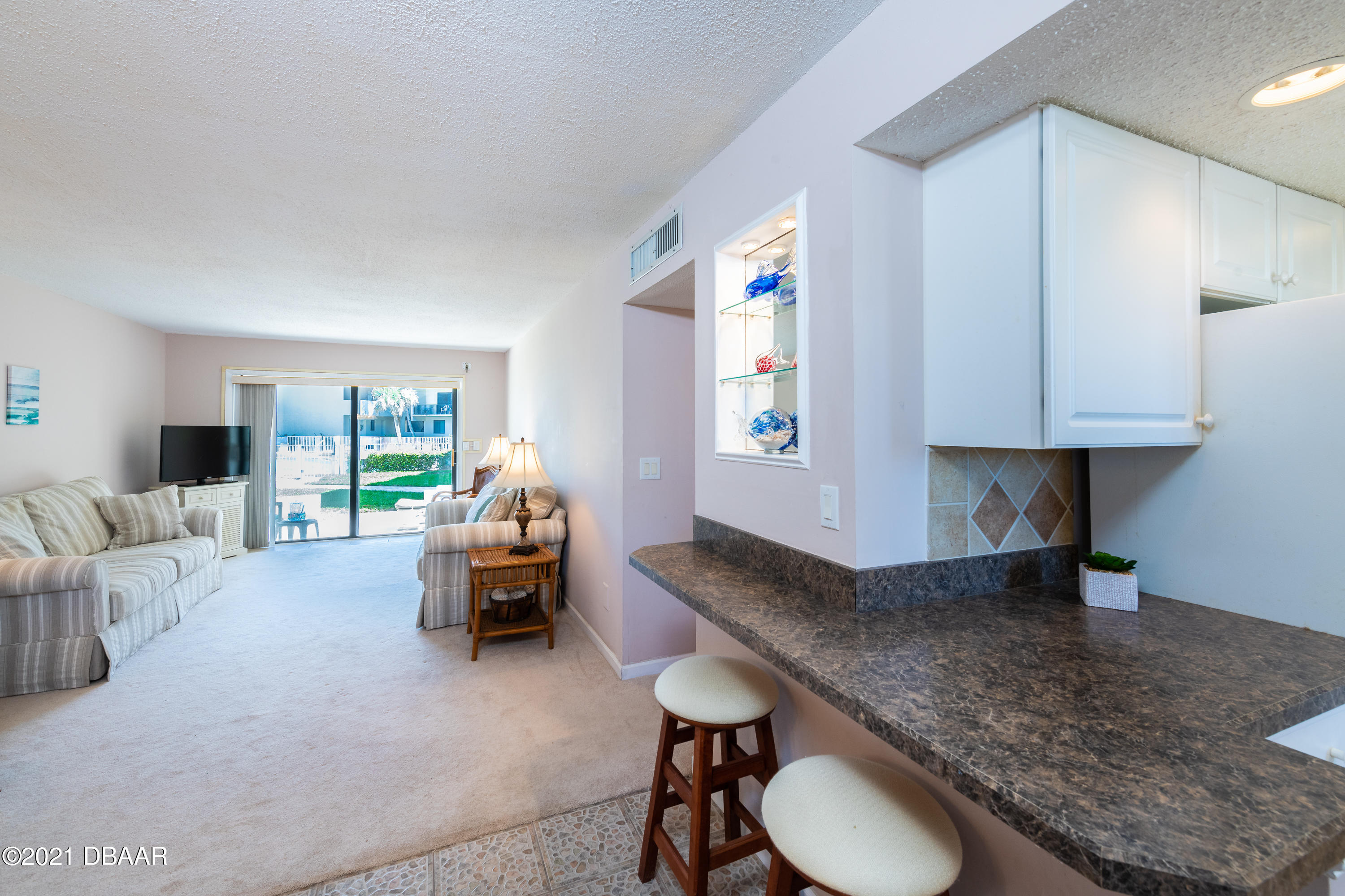 935 Ocean Shore Boulevard, Unit 110 Ormond Beach, FL 32176 - Photo 15 of 21 a living room with furniture and a couch