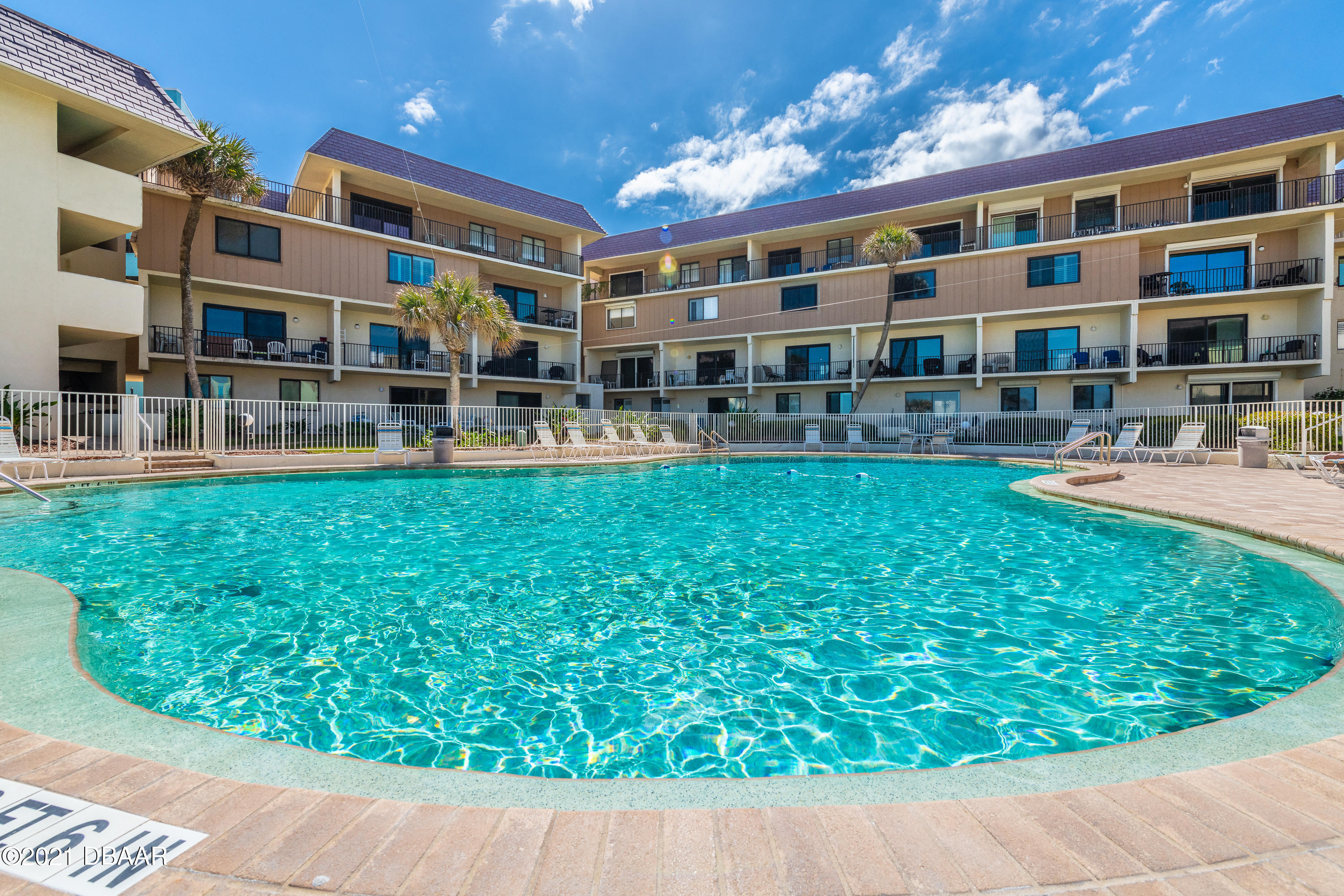 935 Ocean Shore Boulevard, Unit 110 Ormond Beach, FL 32176 - Photo 19 of 21 a front view of building with yard