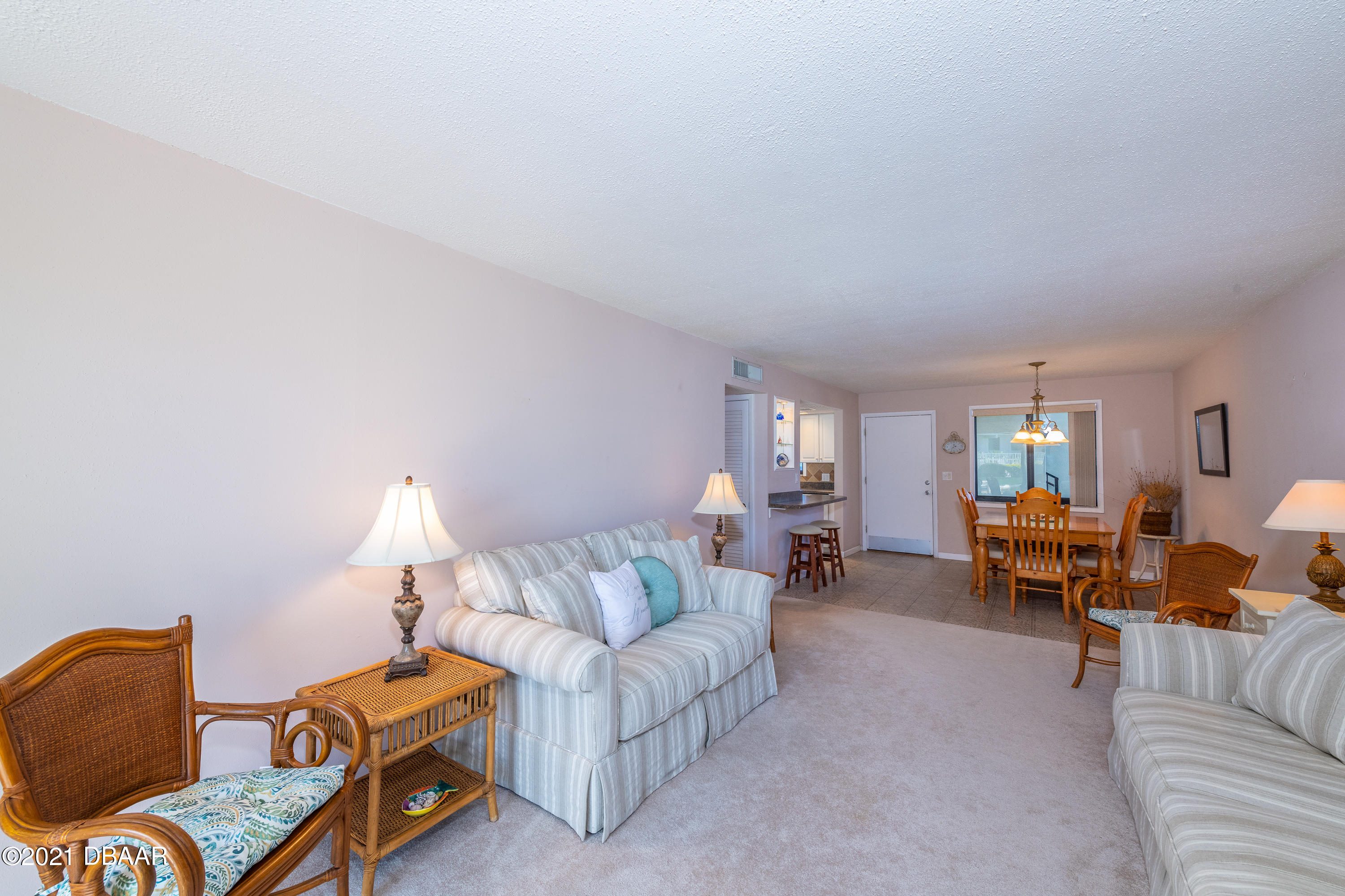 935 Ocean Shore Boulevard, Unit 110 Ormond Beach, FL 32176 - Photo 3 of 21 a living room with furniture and a couch