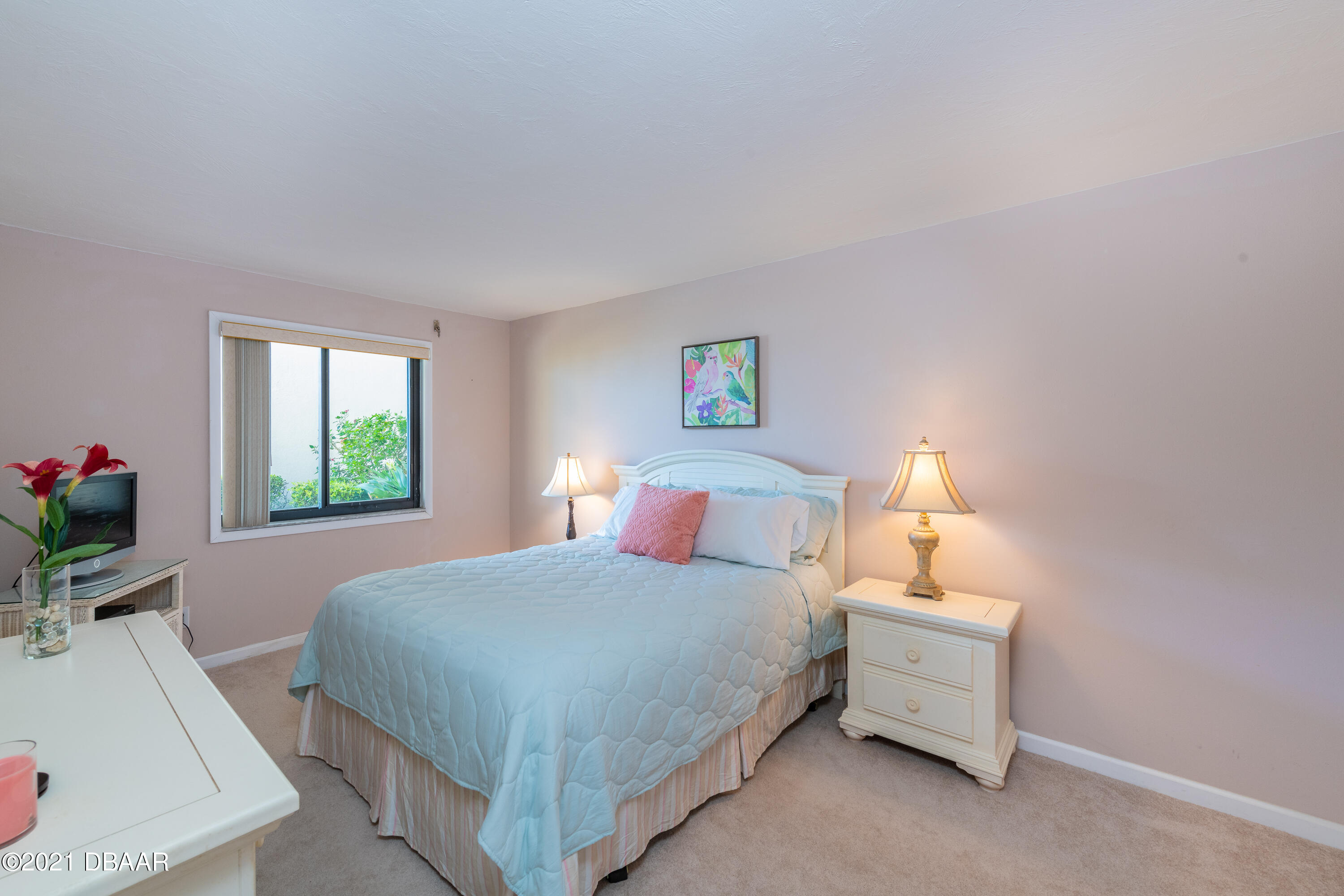 935 Ocean Shore Boulevard, Unit 110 Ormond Beach, FL 32176 - Photo 5 of 21 a bedroom with a bed and a window