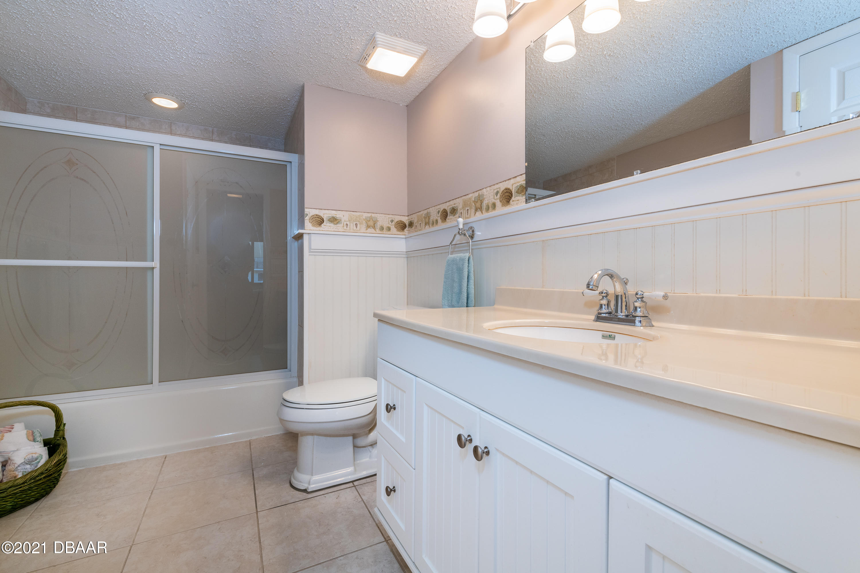 935 Ocean Shore Boulevard, Unit 110 Ormond Beach, FL 32176 - Photo 6 of 21 a bathroom with a sink a toilet and shower