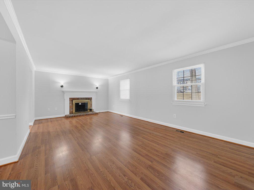 3827 Gawayne Terrace Silver Spring, MD 20906 - Photo 13 of 45 a view of empty room with wooden floor and fireplace