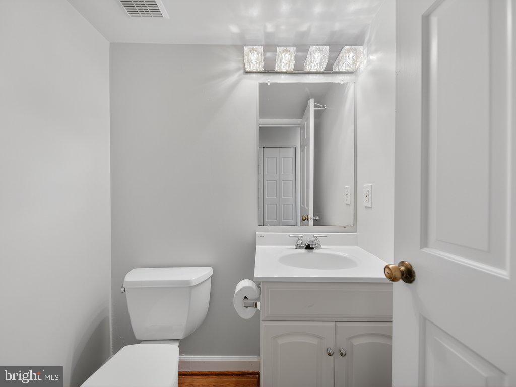 3827 Gawayne Terrace Silver Spring, MD 20906 - Photo 17 of 45 a bathroom with a toilet sink and mirror