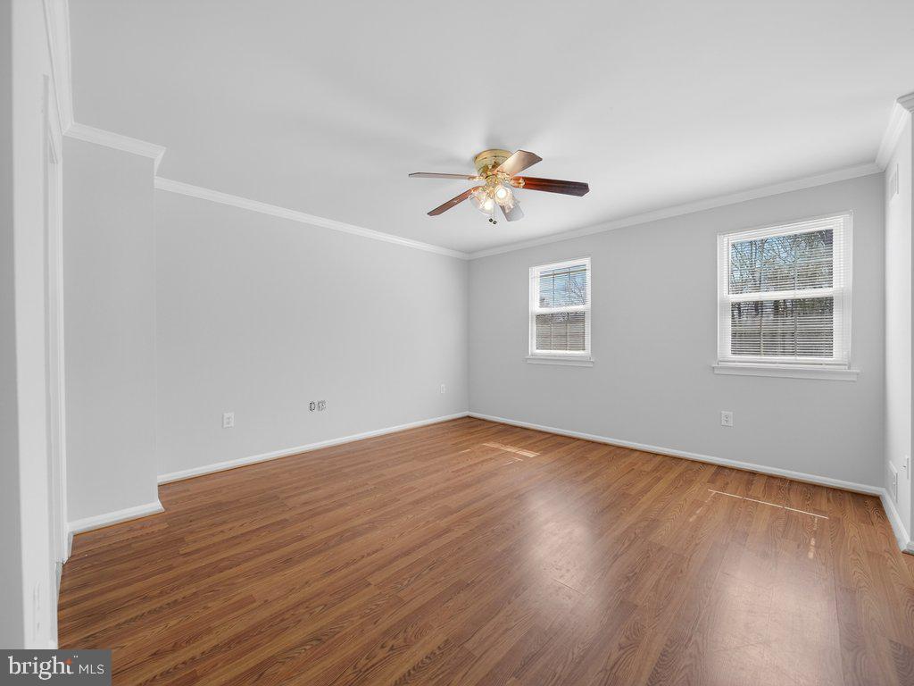 3827 Gawayne Terrace Silver Spring, MD 20906 - Photo 19 of 45 a view of an empty room with a window and wooden floor